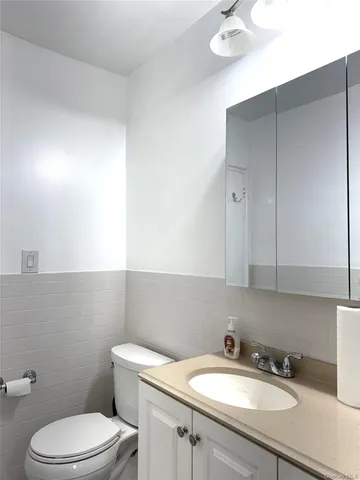 a bathroom with a sink a toilet and mirror