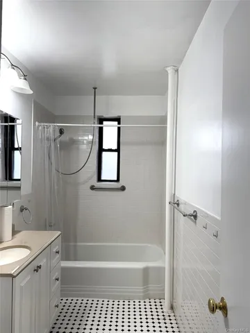 a bathroom with a bathtub a shower a toilet a sink and mirror