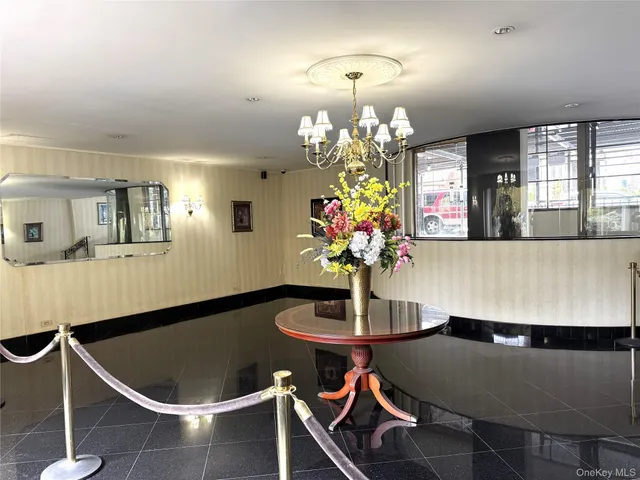 a dining room with furniture and chandelier