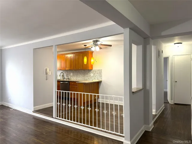 a view of a room with wooden floor and windows