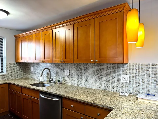 a kitchen with a sink window and cabinets