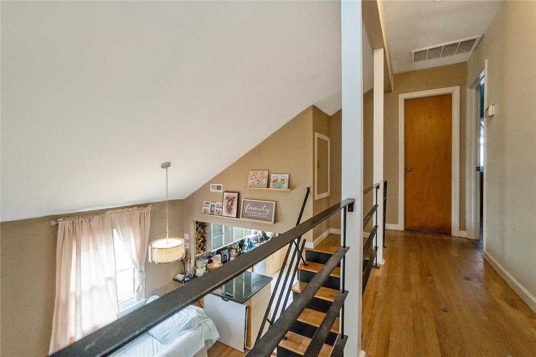 3031 Shakespeare Road Bethlehem, PA 18017 - Photo 15 of 30 A well-lit interior showcases a captivating staircase with sleek black railings, blending modern design with classic wood accents.