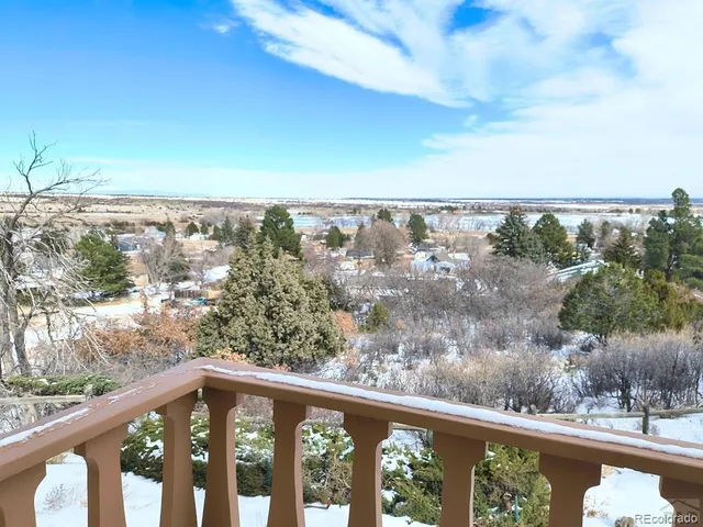 a view of a balcony with wooden fence