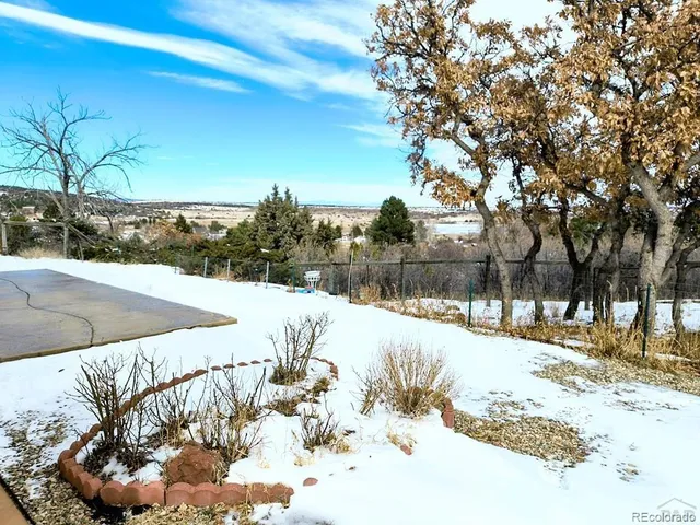 a view of a yard with snow on the road