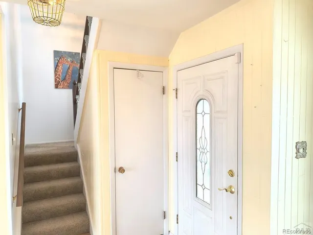 a view of a hallway with wooden floor and entryway