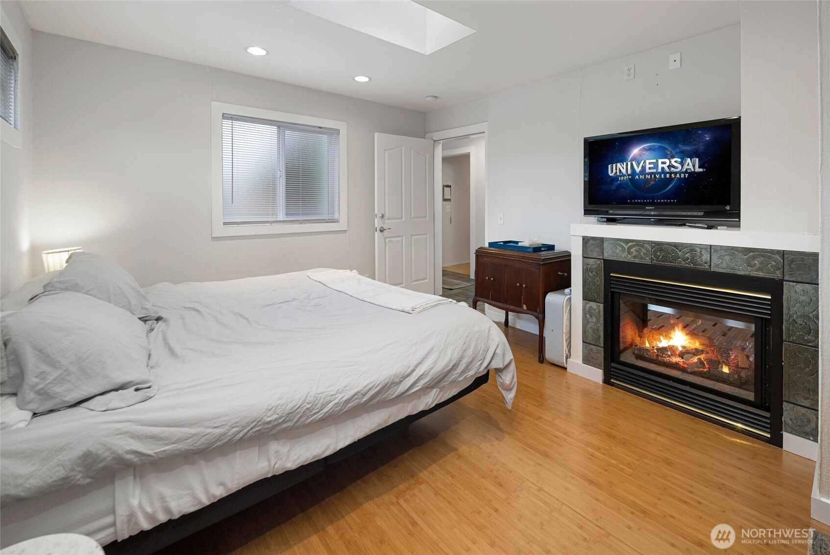 310 Spring Street, Unit F Friday Harbor, WA 98250 - Photo 11 of 20 a bedroom with a bed and a fireplace