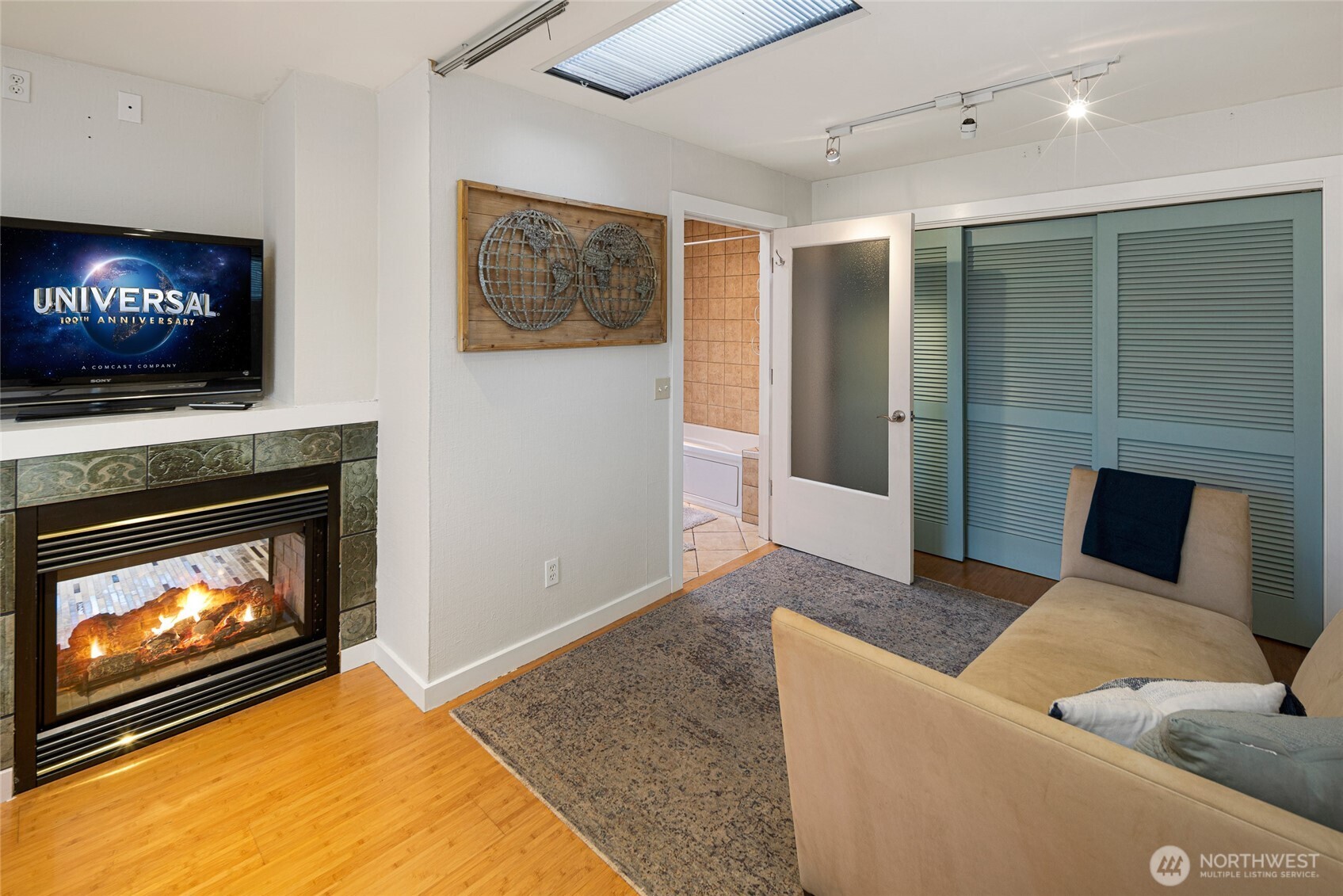 310 Spring Street, Unit F Friday Harbor, WA 98250 - Photo 13 of 20 a living room with furniture a flat screen tv and a fireplace