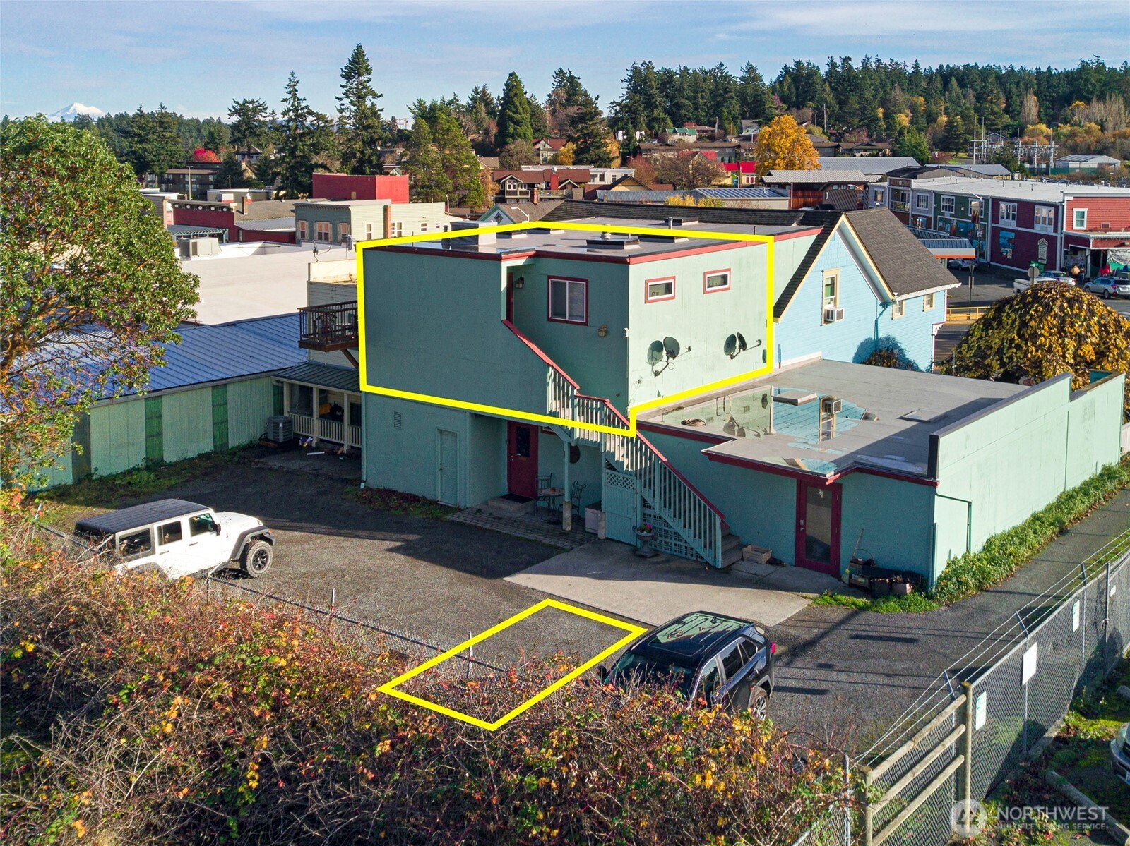 310 Spring Street, Unit F Friday Harbor, WA 98250 - Photo 2 of 20 an aerial view of a house with swimming pool outdoor seating and yard in back