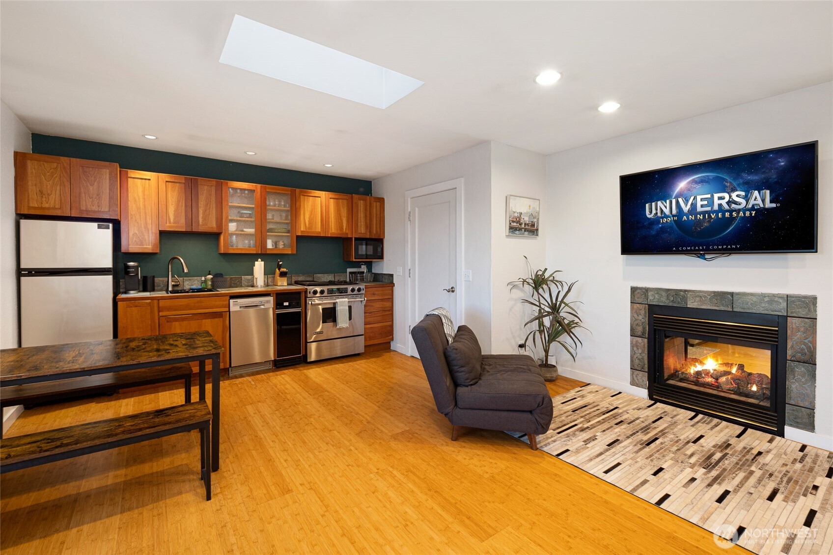 310 Spring Street, Unit F Friday Harbor, WA 98250 - Photo 5 of 20 a living room with furniture a flat screen tv and a fireplace