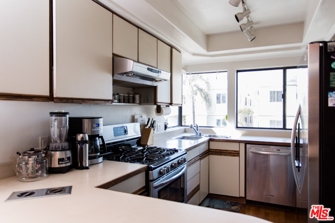 30 Lighthouse Street, Unit 1 Marina del Rey, CA 90292 - Photo 11 of 20 a kitchen with stainless steel appliances granite countertop a sink stove and cabinets