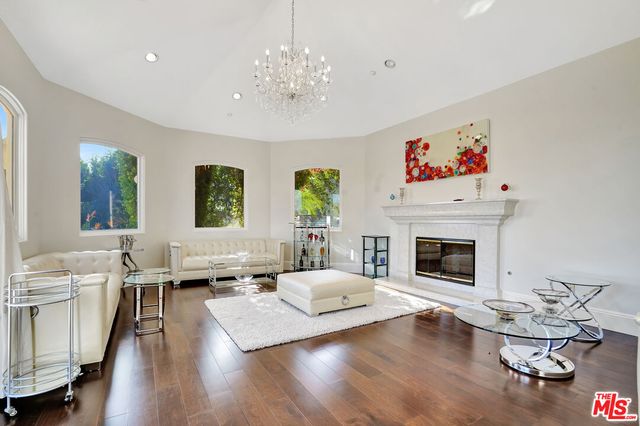 a living room with furniture fireplace and window