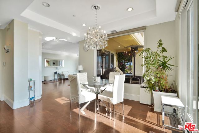a view of a dining room with furniture wooden floor and chandelier