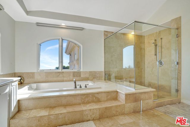 a spacious bathroom with a double vanity sink mirror and double