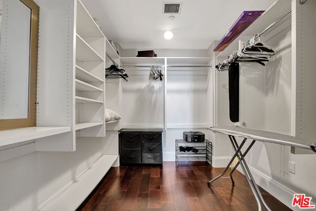 a bedroom with a large bed and a flat screen tv