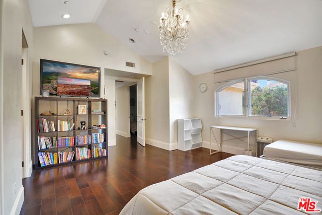 a bathroom with a bathtub shower sink vanity mirror and toilet
