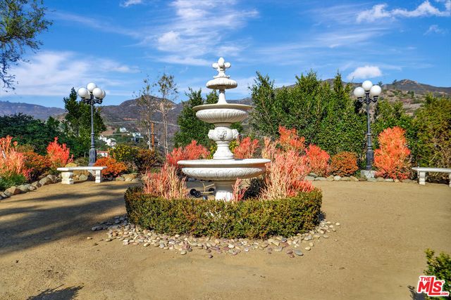 a view of swimming pool with a lounge chairs