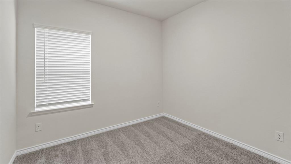 447 Epiphany Lane Lavon, TX 75166 - Photo 25 of 31 Neutral-toned interior room featuring light gray walls, plush gray carpeting, and white trim
