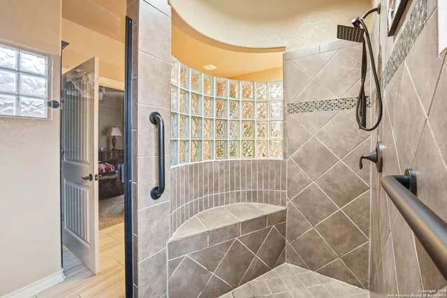 a bedroom with a bed and large mirror with window