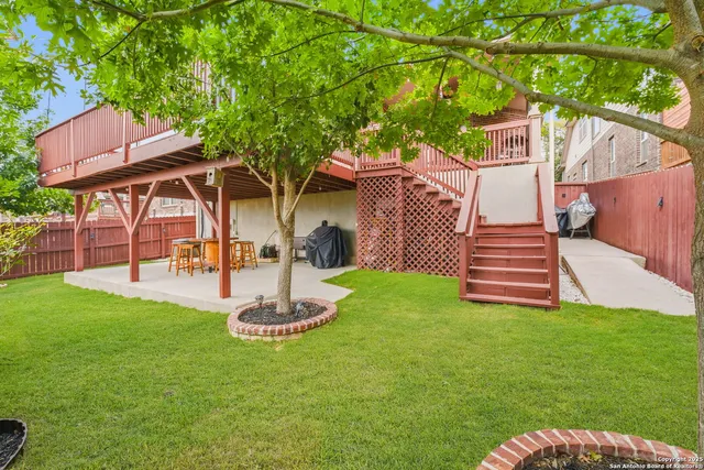 a front view of house with a garden and trees