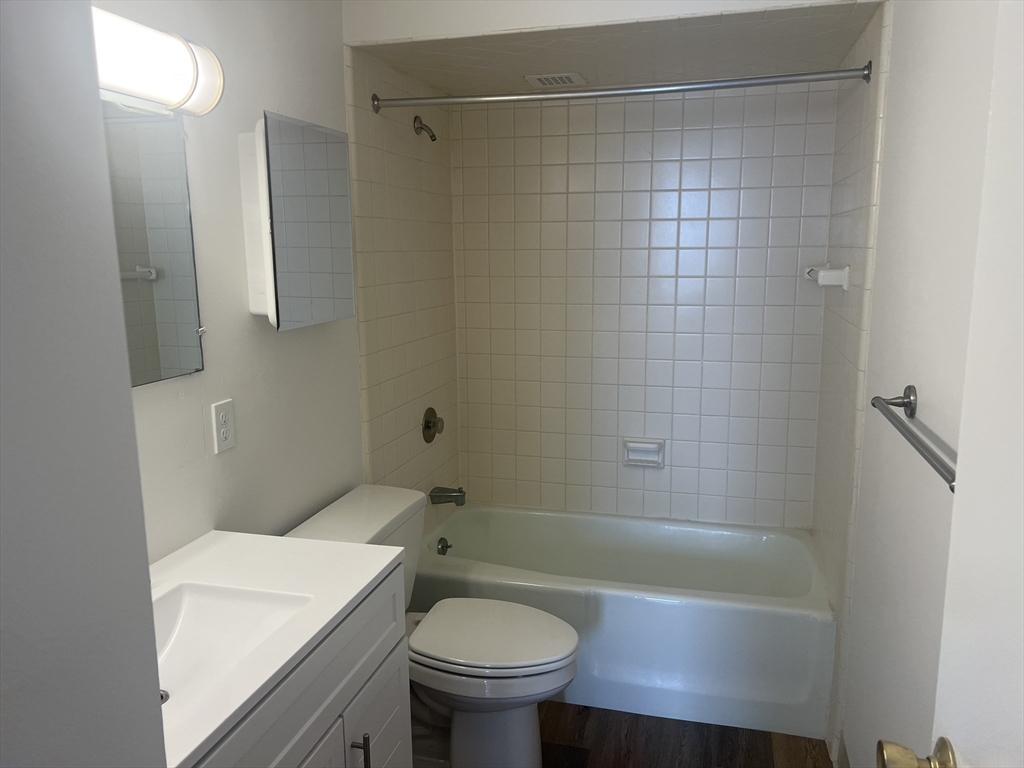 1 Pond Street, Unit 8K Winthrop, MA 02152 - Photo 9 of 14 a bathroom with a sink a toilet and shower