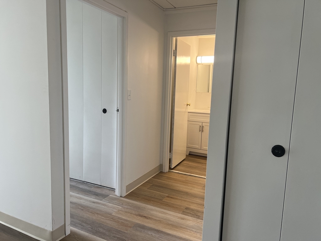 1 Pond Street, Unit 8K Winthrop, MA 02152 - Photo 10 of 14 a view of a hallway with wooden floor