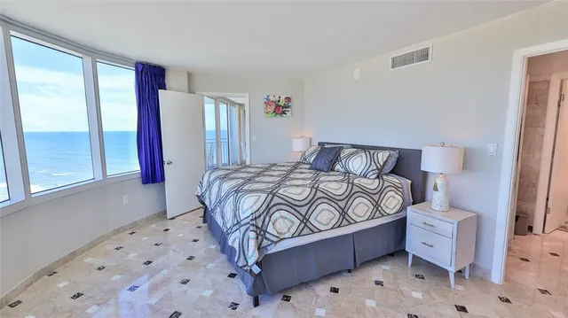 a view of a bedroom with a bed and balcony