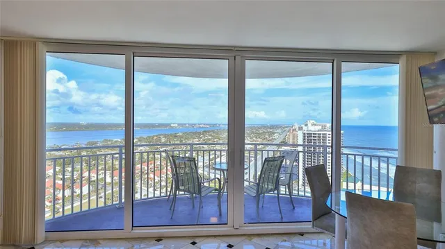 a view of a room with wooden floor and windows