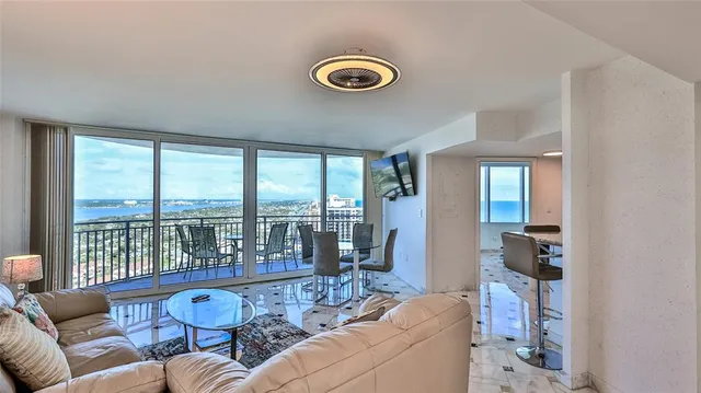 a living room with furniture and a floor to ceiling window