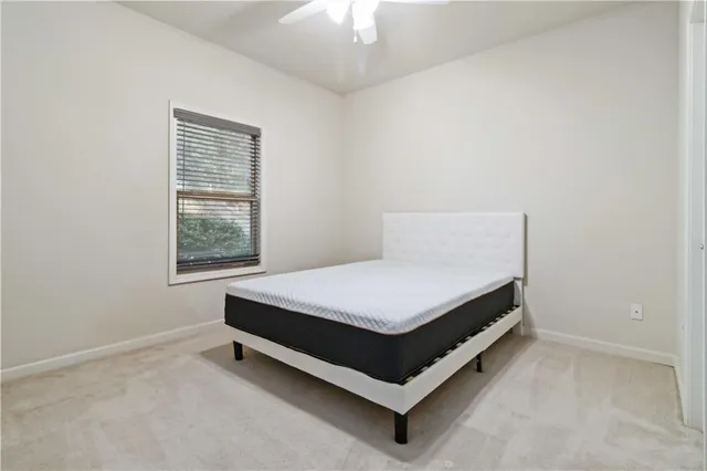 a bed sitting in a room next to a window