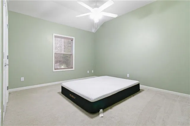 a bedroom with a bed and window