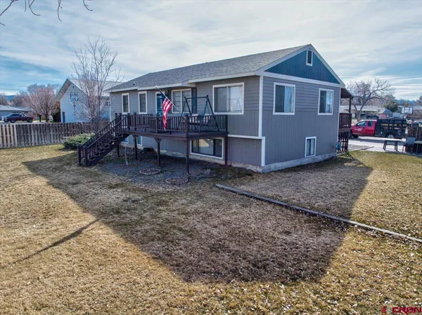 a view of a house with a yard and roof