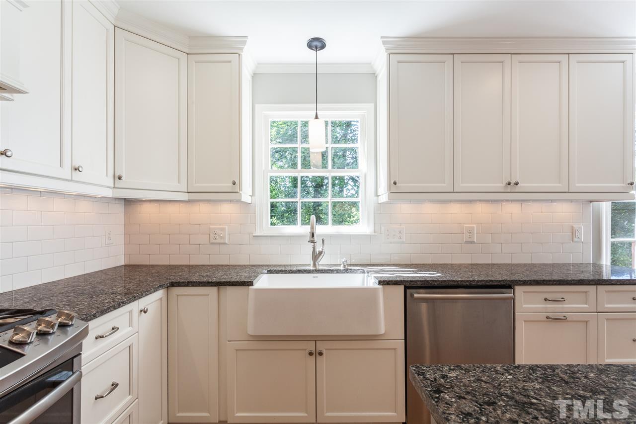 2003 Nancy Ann Drive Raleigh, NC 27607 - Photo 19 of 30 a kitchen with granite countertop white cabinets and white appliances