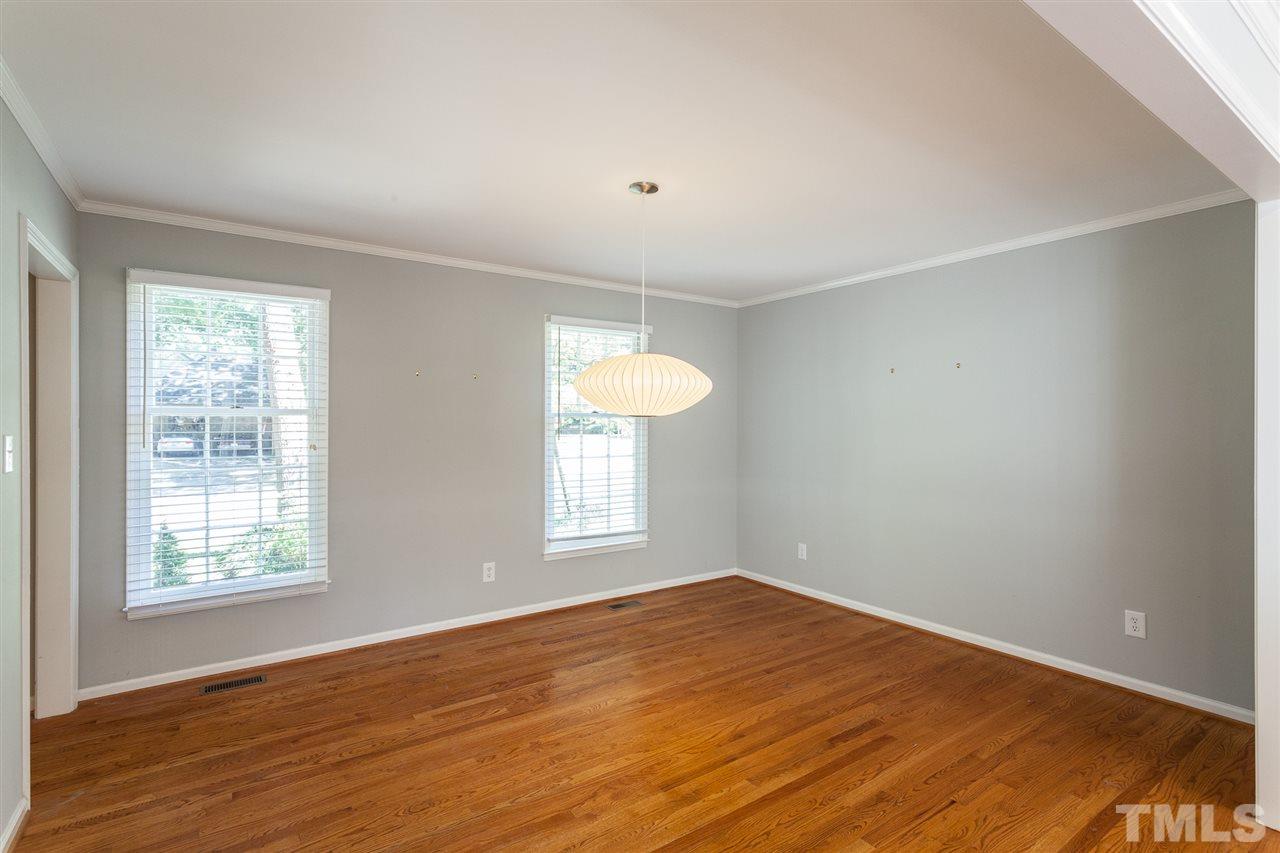 2003 Nancy Ann Drive Raleigh, NC 27607 - Photo 21 of 30 an empty room with wooden floor and windows
