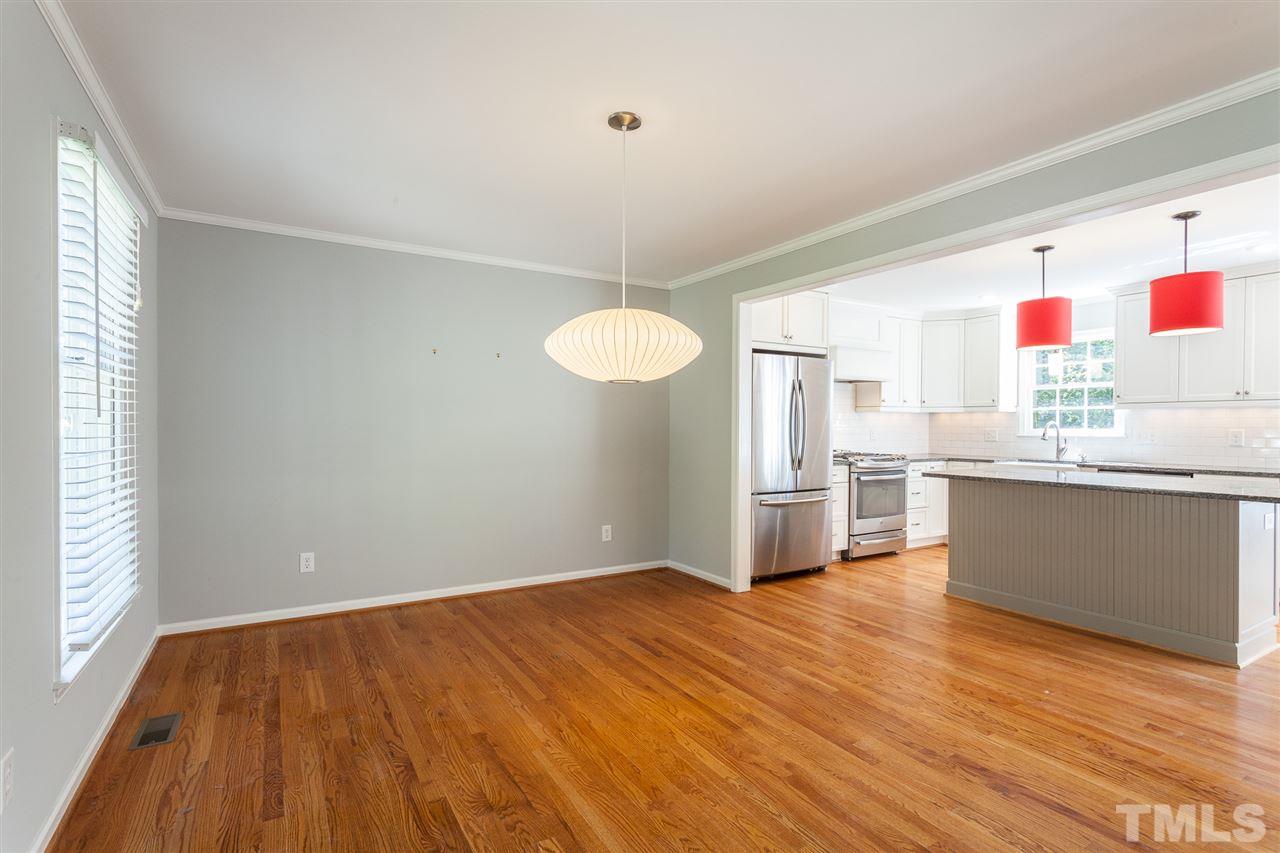 2003 Nancy Ann Drive Raleigh, NC 27607 - Photo 22 of 30 a kitchen with wooden floors and white cabinets