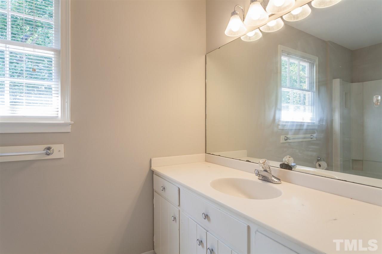 2003 Nancy Ann Drive Raleigh, NC 27607 - Photo 25 of 30 a bathroom with a sink and a mirror