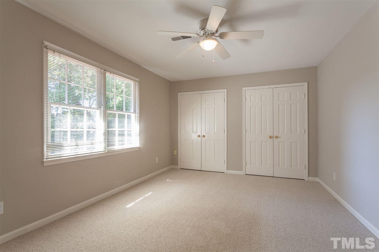 2003 Nancy Ann Drive Raleigh, NC 27607 - Photo 26 of 30 an empty room with chandelier fan and windows