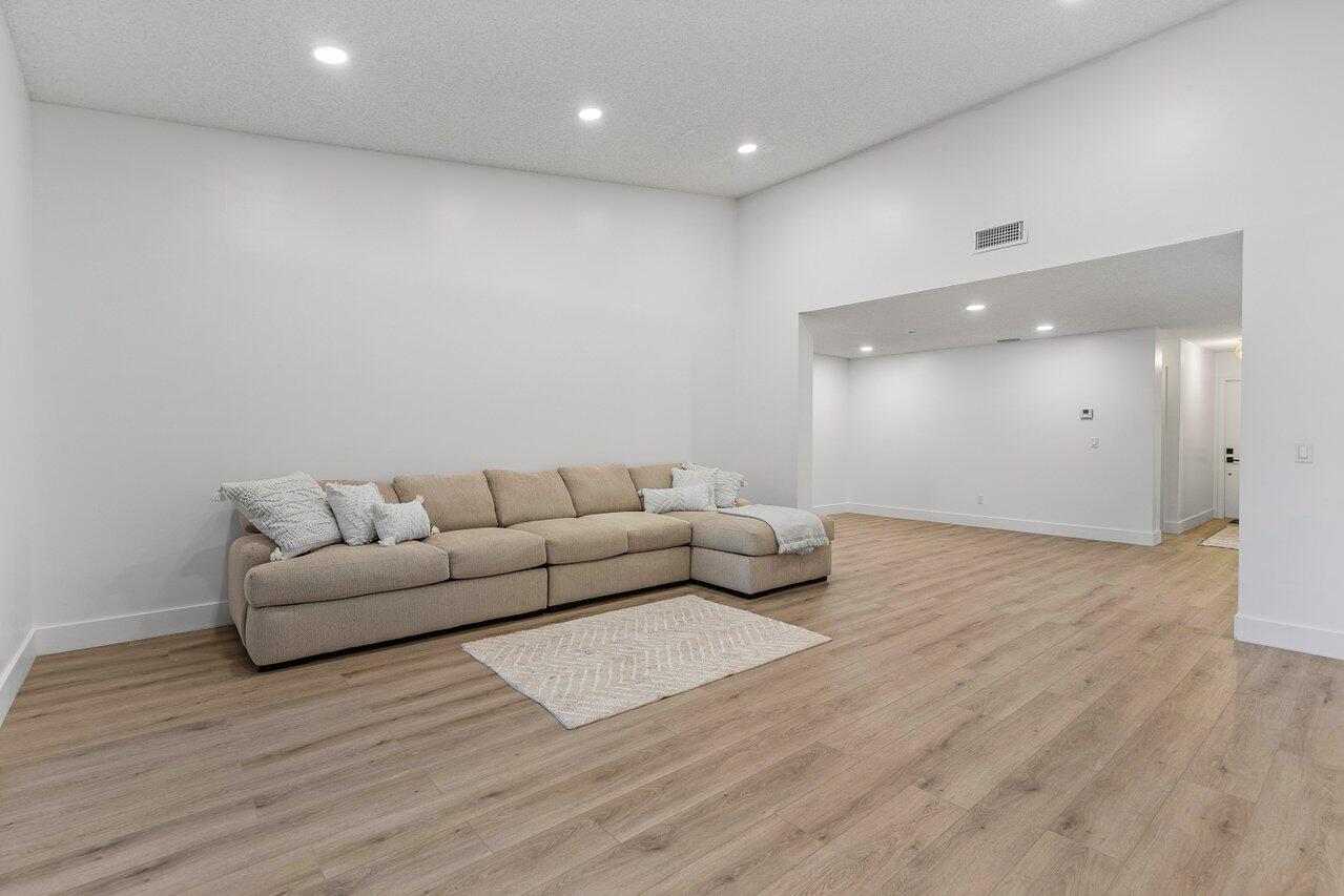 9346 Sable Ridge Circle, Unit B Boca Raton, FL 33428 - Photo 8 of 25 a living room with furniture and a wooden floor