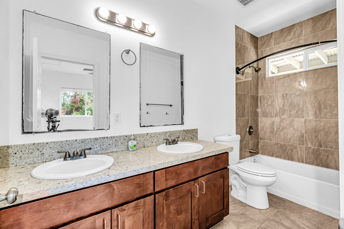 15-1136 Ama U Road Keaau, HI 96749 - Photo 17 of 25 a bathroom with a granite countertop sink toilet a mirror and shower