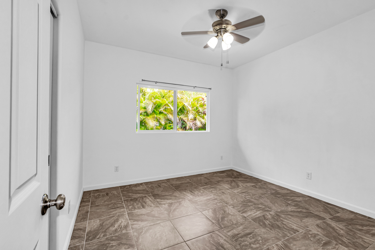 15-1136 Ama U Road Keaau, HI 96749 - Photo 19 of 25 an empty room with a window and a ceiling fan