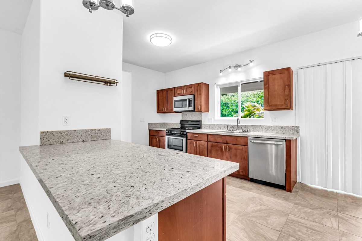 15-1136 Ama U Road Keaau, HI 96749 - Photo 8 of 25 a kitchen with stainless steel appliances granite countertop a sink stove and refrigerator