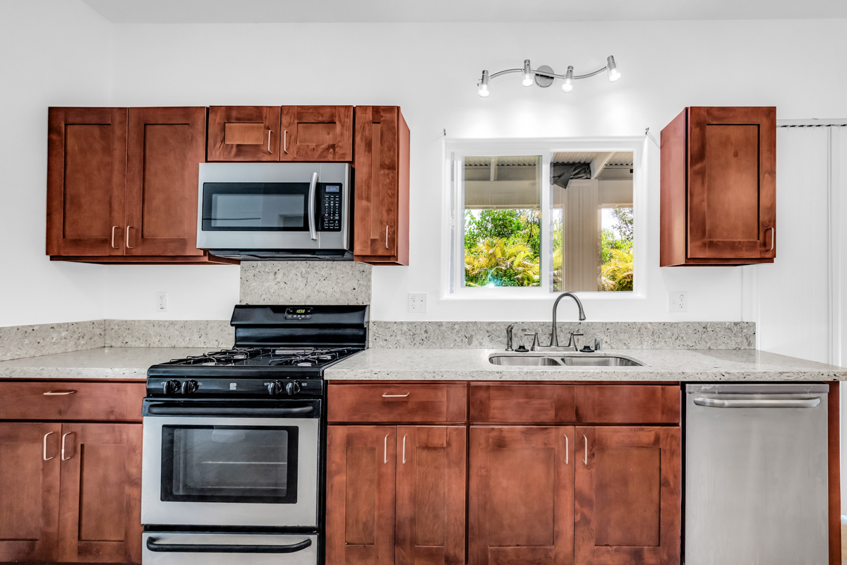 15-1136 Ama U Road Keaau, HI 96749 - Photo 9 of 25 a kitchen with stainless steel appliances granite countertop a stove microwave and sink