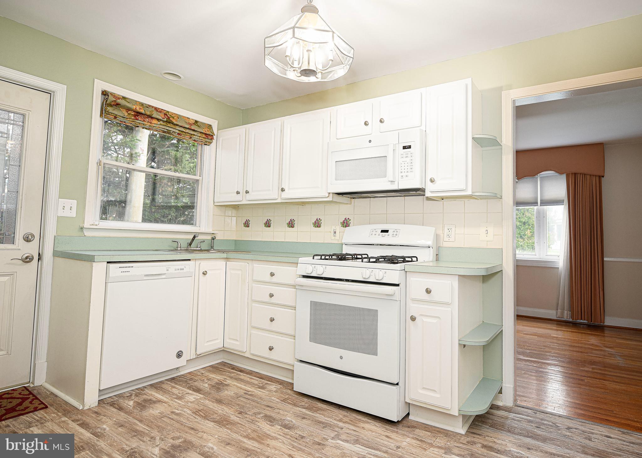 7202 Old Harford Road Baltimore, MD 21234 - Photo 6 of 21 Kitchen with white appliances and cabinetry