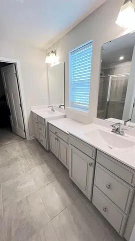 a bathroom with a sink vanity and mirror