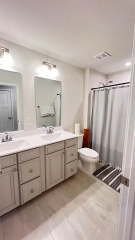 a bathroom with a double vanity sink and mirror