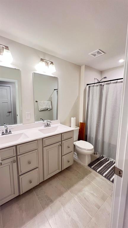 136 Salt Lk Lane Hoschton, GA 30548 - Photo 14 of 22 a bathroom with a double vanity sink and mirror