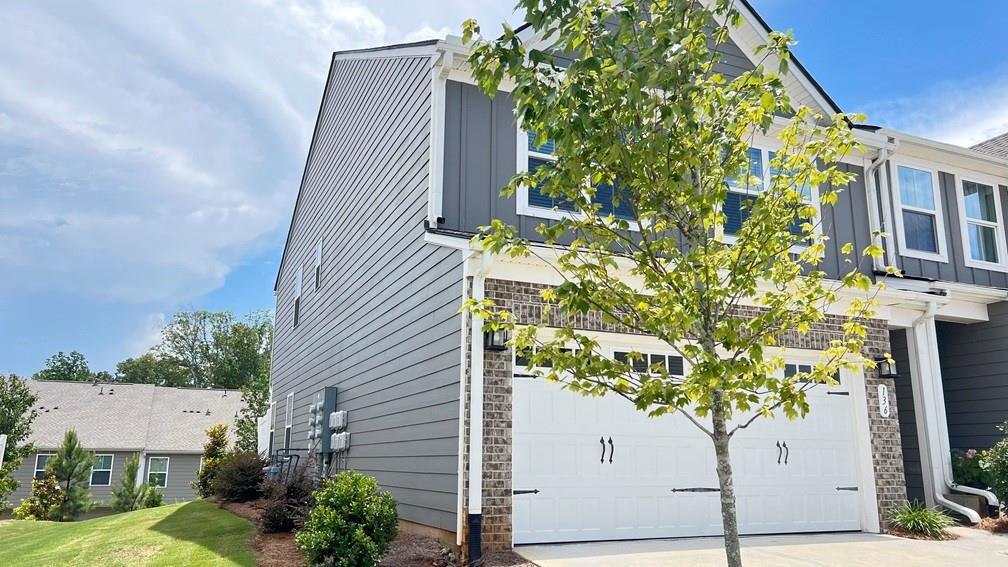 136 Salt Lk Lane Hoschton, GA 30548 - Photo 2 of 22 a plant that is sitting in front of a house