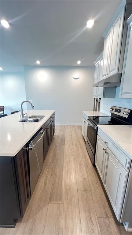 136 Salt Lk Lane Hoschton, GA 30548 - Photo 6 of 22 a kitchen with granite countertop a sink stove and cabinets