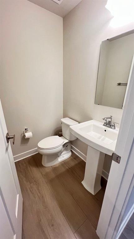 136 Salt Lk Lane Hoschton, GA 30548 - Photo 8 of 22 a bathroom with a sink mirror and toilet