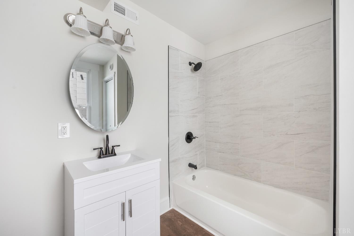 2927 Langhorne Road Lynchburg, VA 24501 - Photo 12 of 48 a bathroom with a sink mirror and a bathtub
