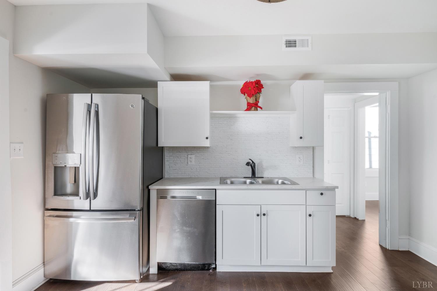 2927 Langhorne Road Lynchburg, VA 24501 - Photo 15 of 48 a kitchen with cabinets stainless steel appliances and wooden floor